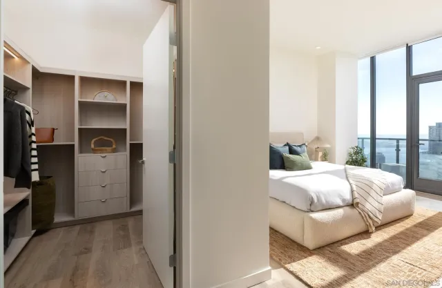 a large kitchen with a large counter top furniture a sink and stainless steel appliances