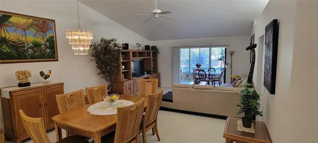 a view of a dining room with furniture and chandelier