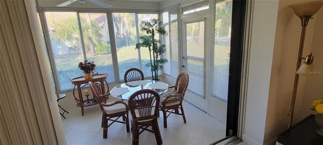a view of a dining room with furniture large windows and wooden floor