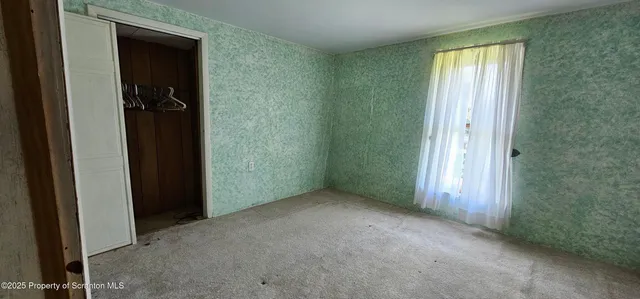 a bedroom with a bed and a walk in closet