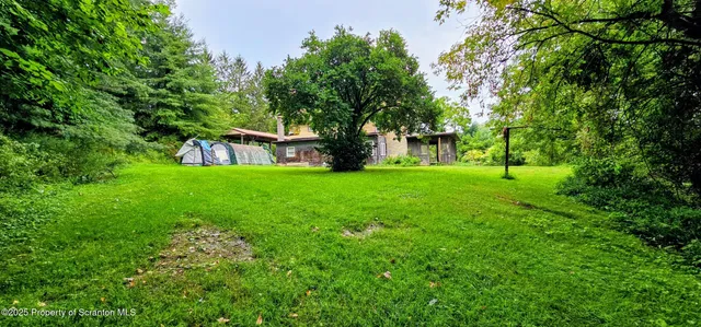 a backyard of a house with lots of green space