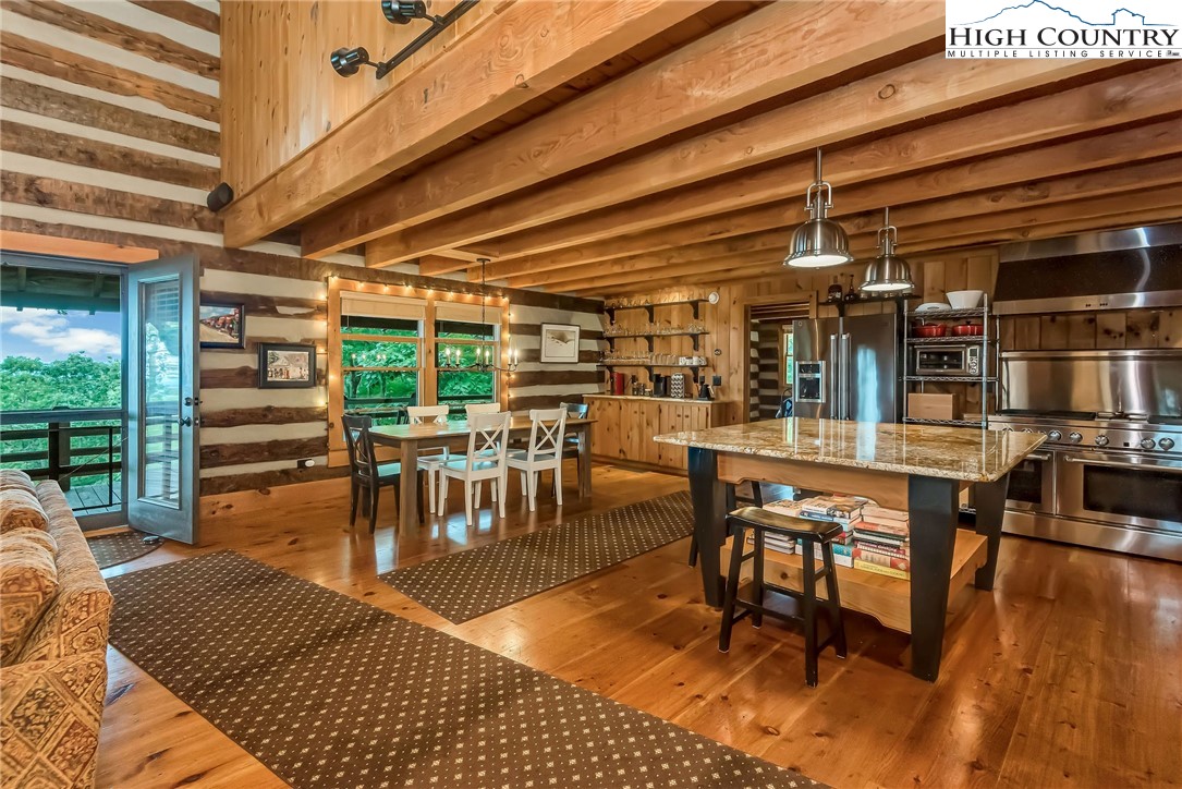 1810 Homestead Road Todd, NC 28684 - Photo 11 of 50 a dining room with furniture and wooden floor