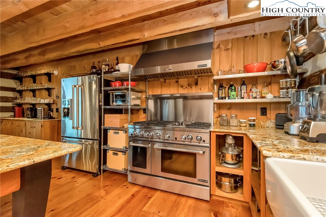 1810 Homestead Road Todd, NC 28684 - Photo 12 of 50 a kitchen with stainless steel appliances granite countertop a stove and a refrigerator