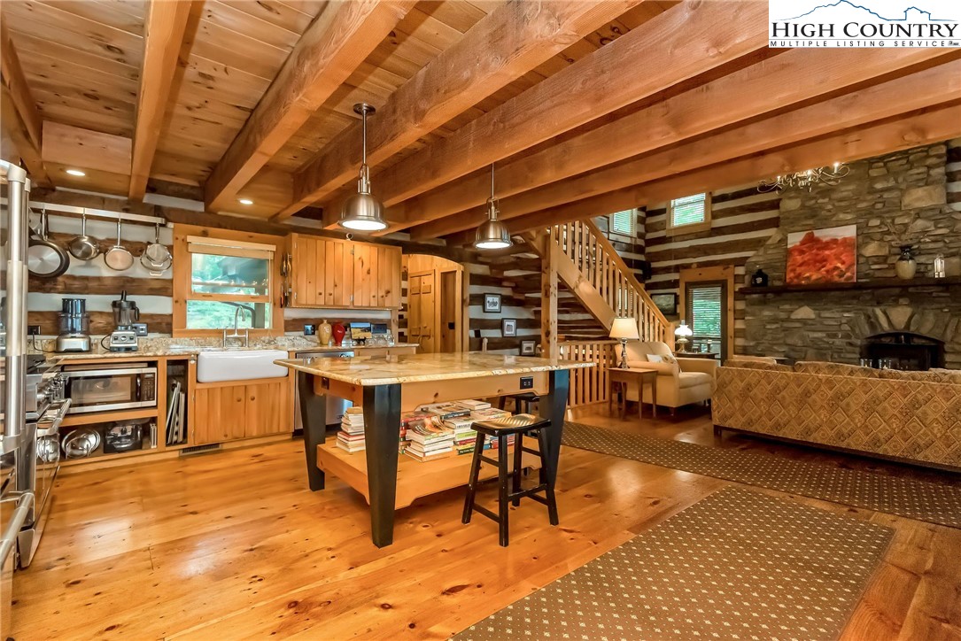 1810 Homestead Road Todd, NC 28684 - Photo 14 of 50 a view of a patio with table and chairs with wooden floor