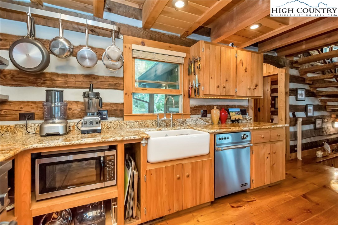 1810 Homestead Road Todd, NC 28684 - Photo 15 of 50 a kitchen with stainless steel appliances granite countertop a stove and a sink