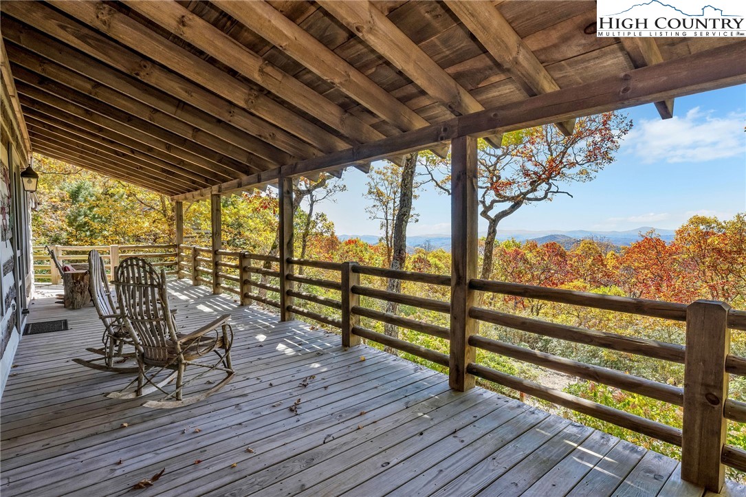 1810 Homestead Road Todd, NC 28684 - Photo 21 of 50 a view of a chairs and table in patio with wooden floor