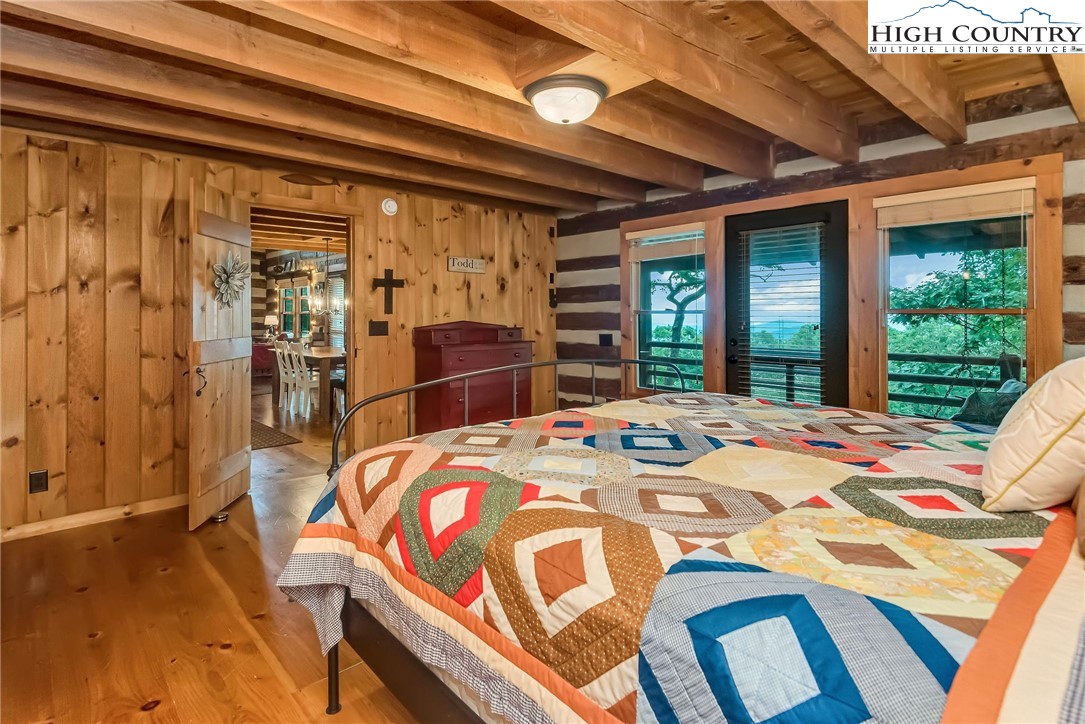 1810 Homestead Road Todd, NC 28684 - Photo 24 of 50 a bed sitting in a bedroom next to a window