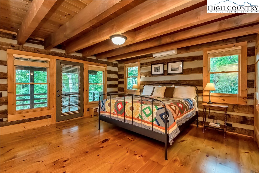 1810 Homestead Road Todd, NC 28684 - Photo 25 of 50 a bed sitting in a spacious bedroom next to a window