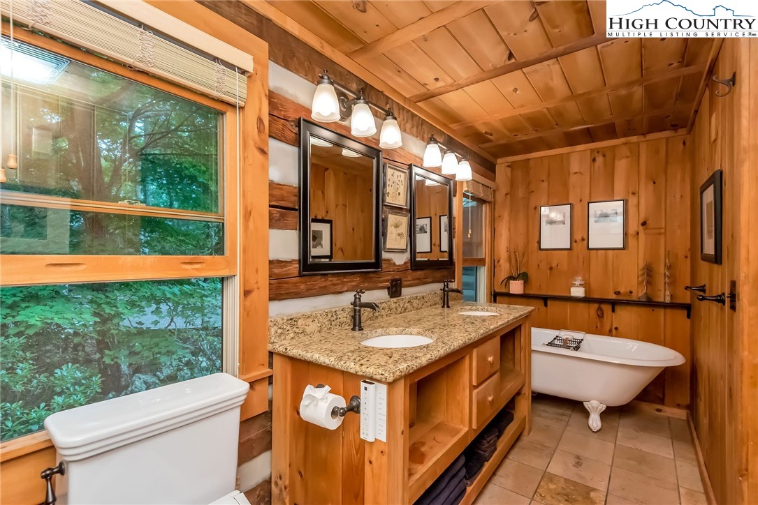1810 Homestead Road Todd, NC 28684 - Photo 26 of 50 a bath room with a sink and mirror