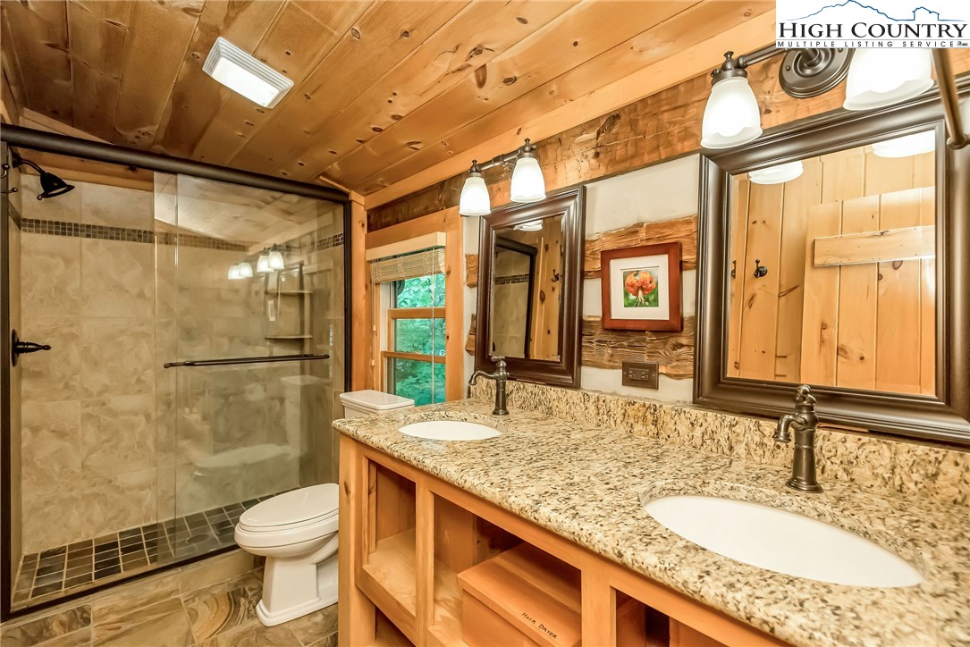 1810 Homestead Road Todd, NC 28684 - Photo 31 of 50 a bathroom with a granite countertop sink toilet and shower