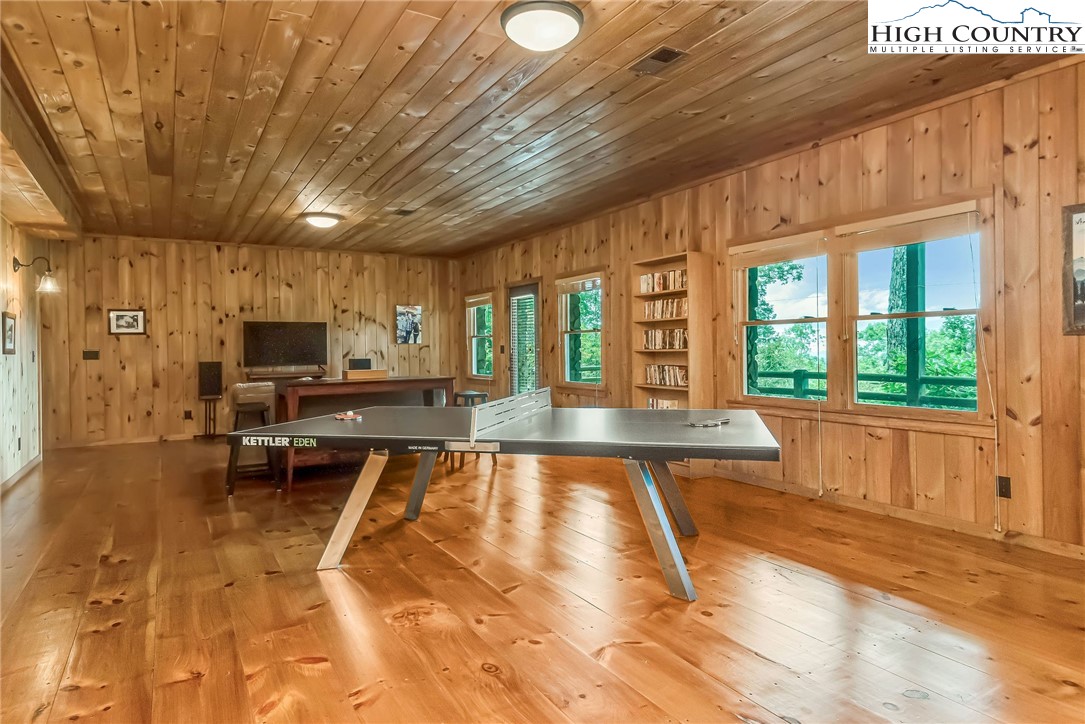 1810 Homestead Road Todd, NC 28684 - Photo 36 of 50 a view of a living room with kitchen island a flat screen tv and a large window