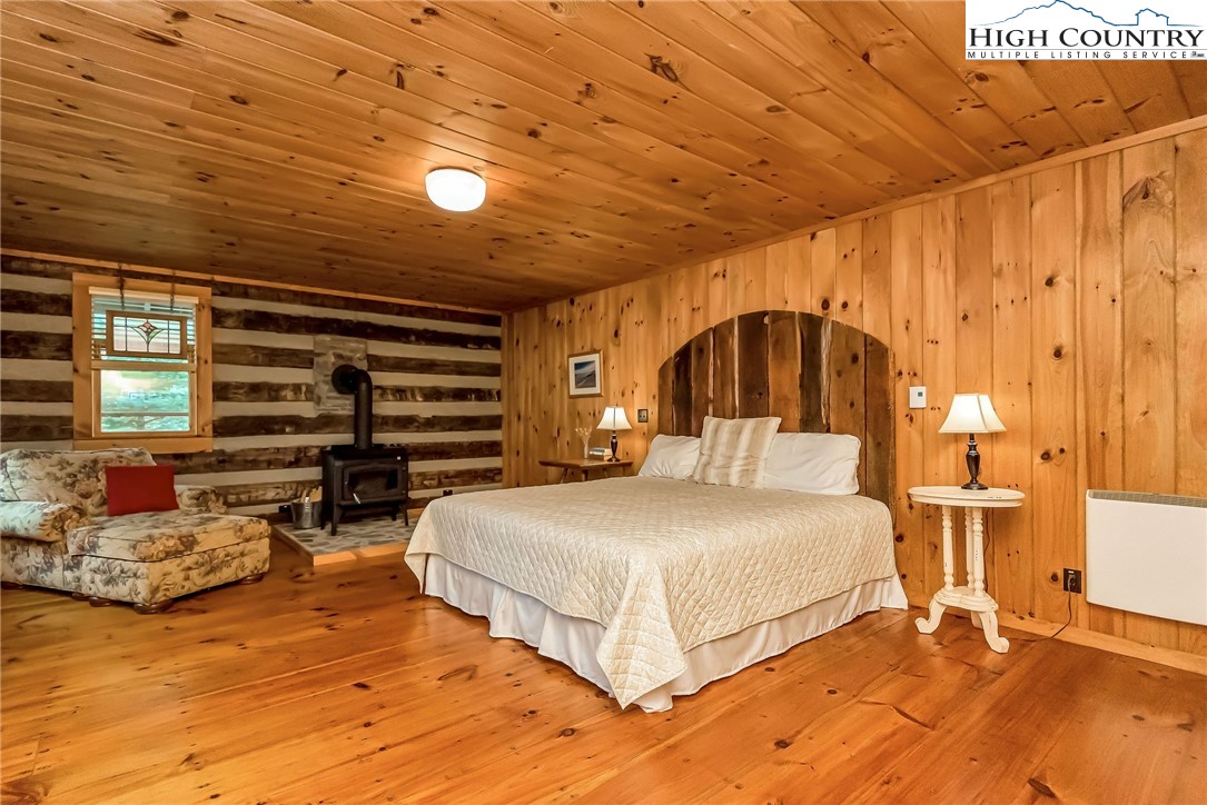 1810 Homestead Road Todd, NC 28684 - Photo 45 of 50 a bedroom with a bed and a night stand