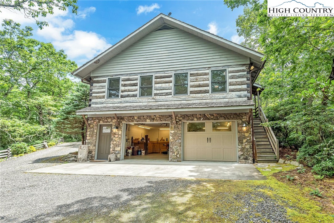 1810 Homestead Road Todd, NC 28684 - Photo 47 of 50 a front view of a house with a yard and garage