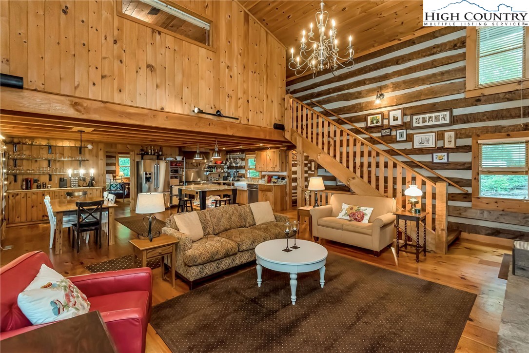 1810 Homestead Road Todd, NC 28684 - Photo 10 of 50 a living room with furniture and a chandelier