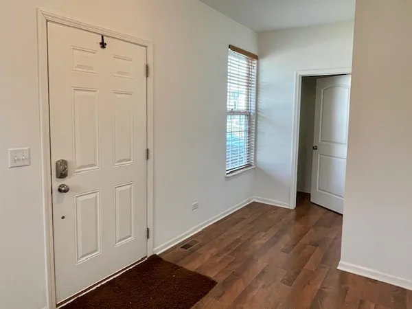 an empty room with windows and closet