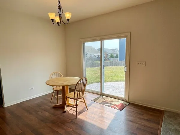 a view of a dining room with furniture wooden floor and a chandelier