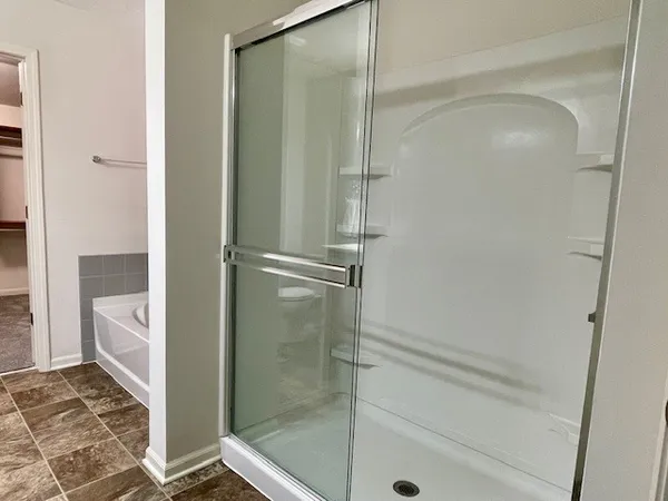 a bathroom with a shower and toilet