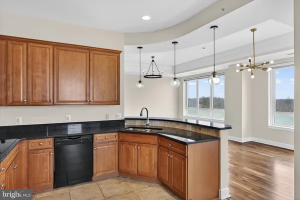 a kitchen with granite countertop a sink and a stove