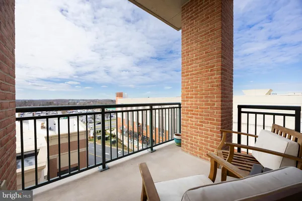 a view of a balcony with furniture