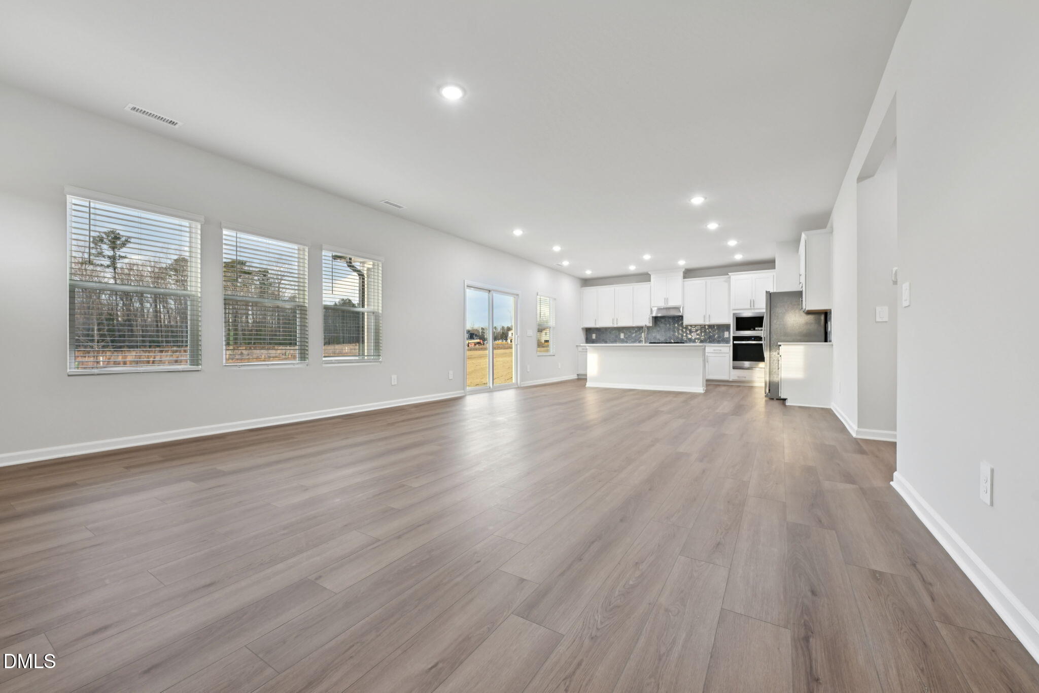 548 Bridger Drive Garner, NC 27529 - Photo 10 of 49 a view of large kitchen with wooden floor and windows