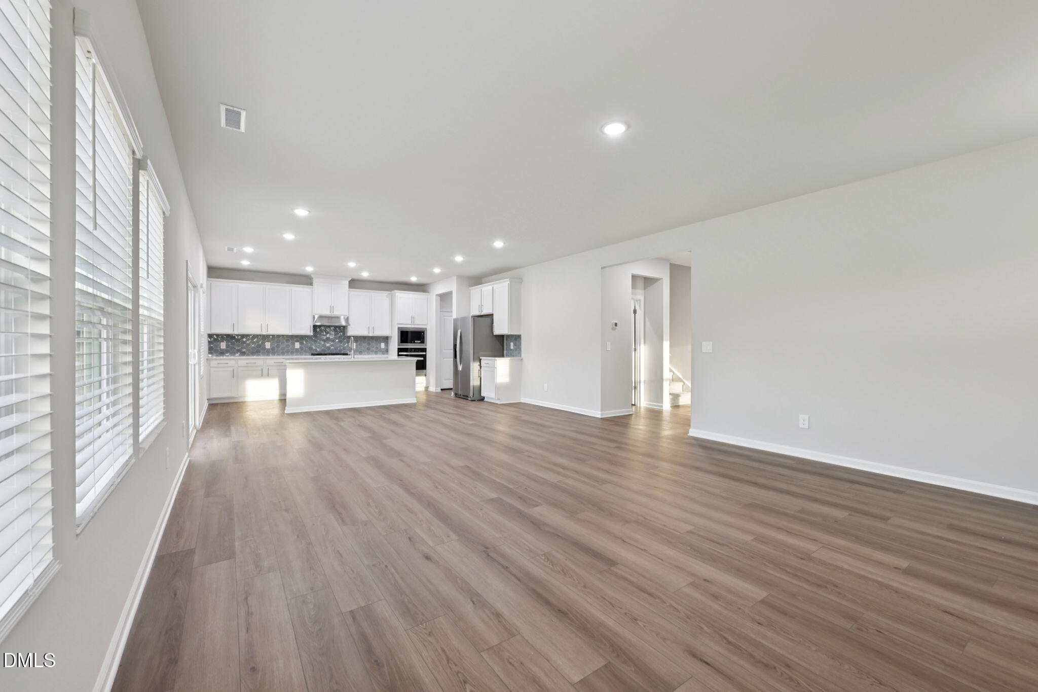 548 Bridger Drive Garner, NC 27529 - Photo 11 of 49 a view of large kitchen with wooden floor and windows