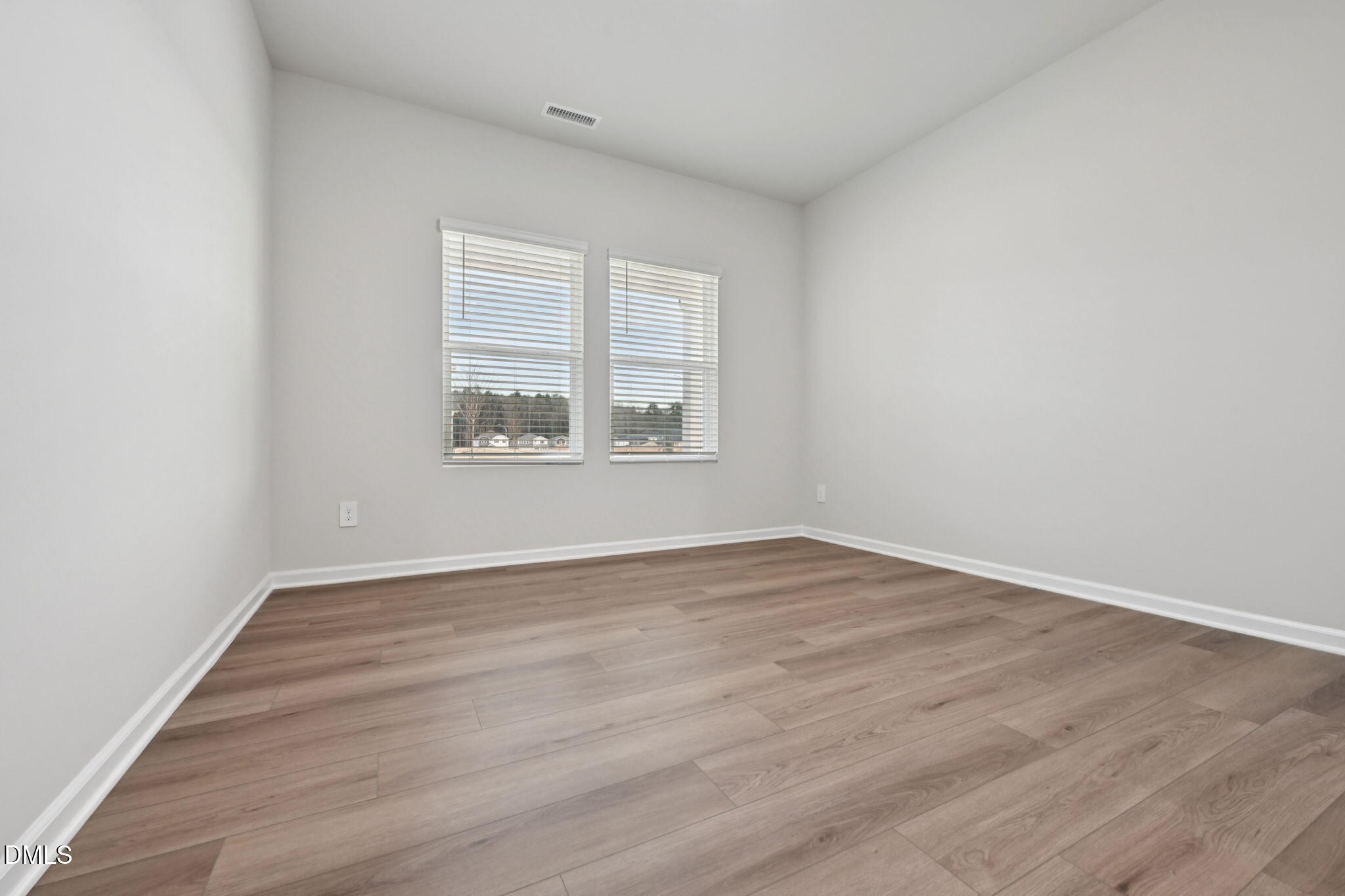 548 Bridger Drive Garner, NC 27529 - Photo 15 of 49 an empty room with wooden floor and windows