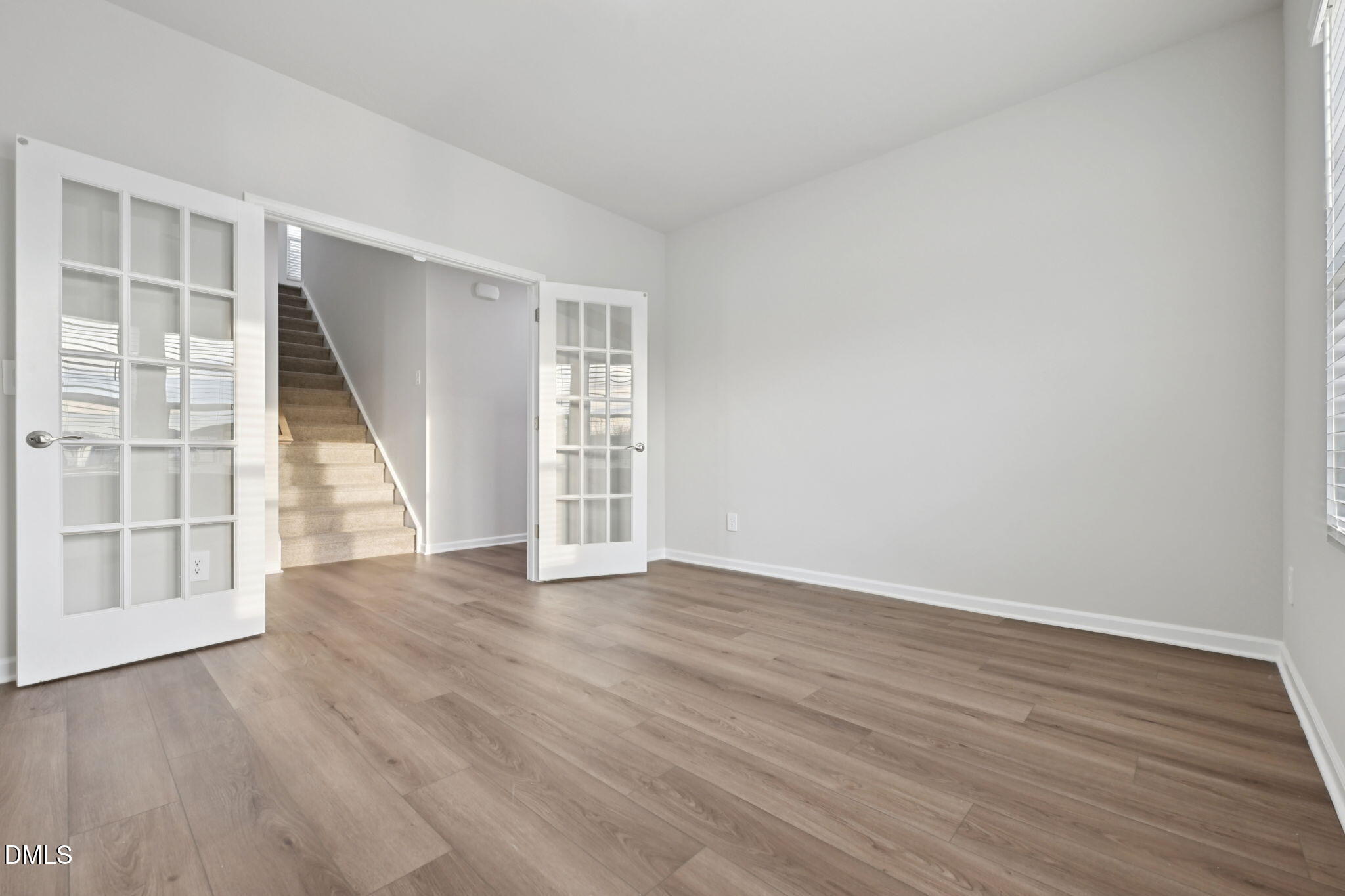 548 Bridger Drive Garner, NC 27529 - Photo 18 of 49 an empty room with wooden floor and windows