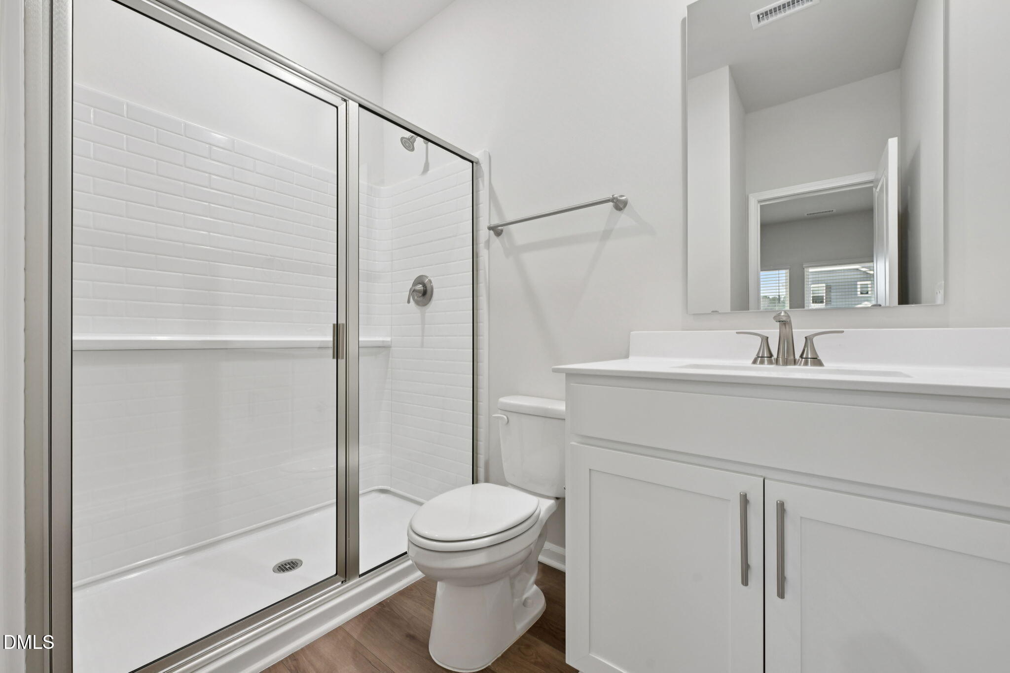 548 Bridger Drive Garner, NC 27529 - Photo 20 of 49 a bathroom with a shower sink vanity mirror and toilet