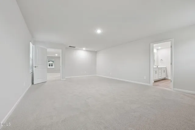 a spacious bathroom with a double vanity sink a mirror and a shower