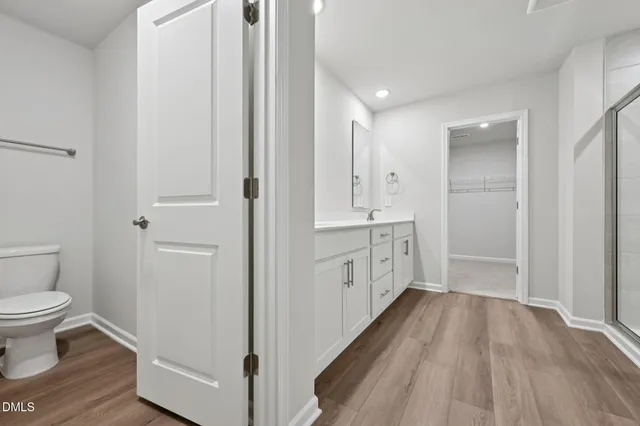 a bathroom with a sink mirror and toilet