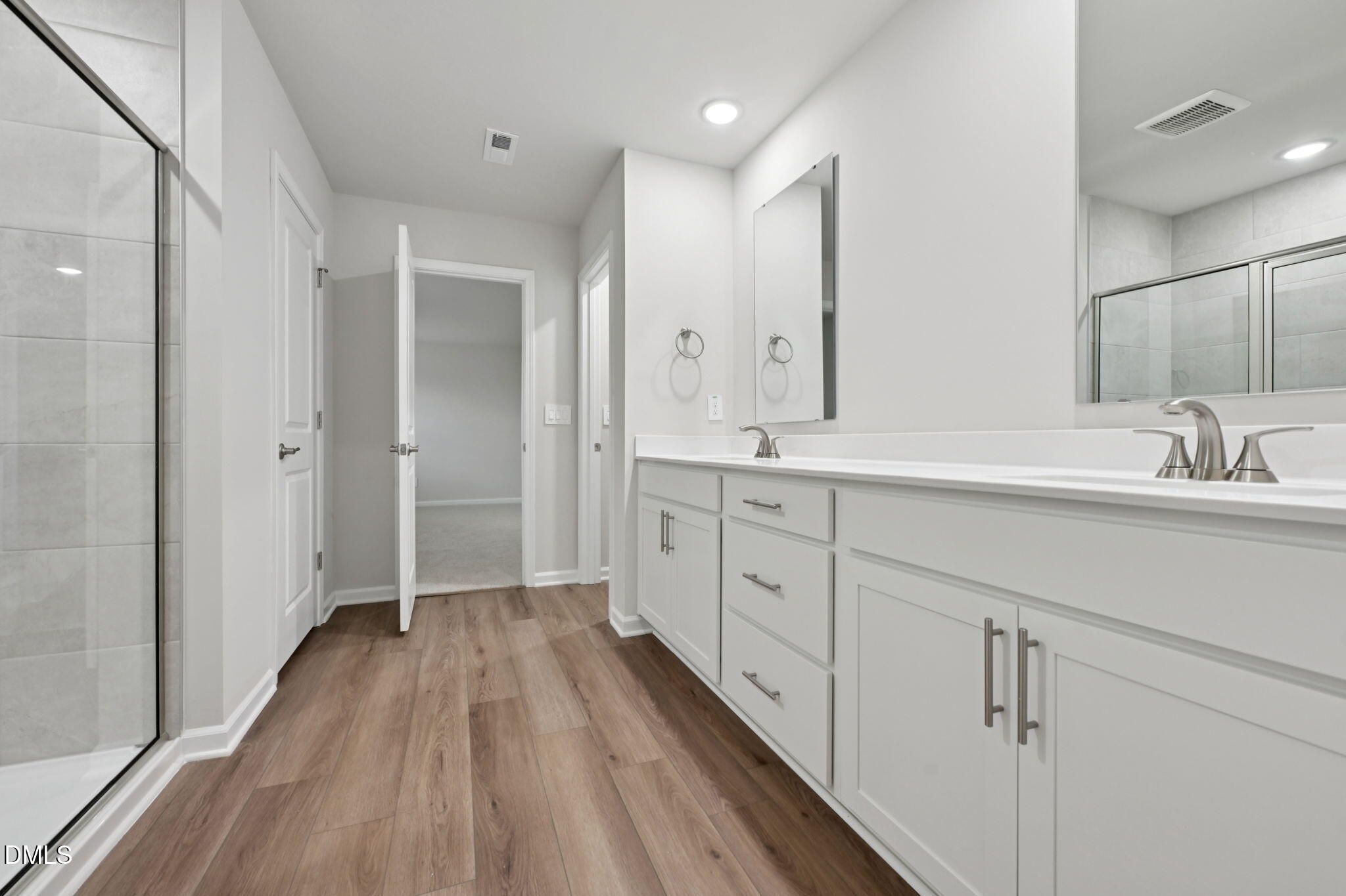 548 Bridger Drive Garner, NC 27529 - Photo 33 of 49 a spacious bathroom with a double vanity sink a mirror and a shower