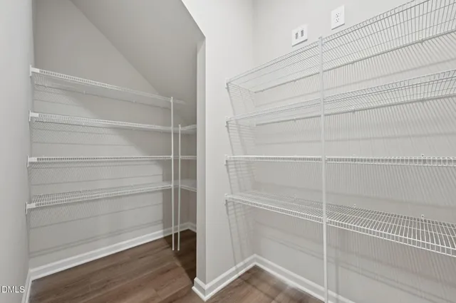 an outdoor view of a house with basket ball court