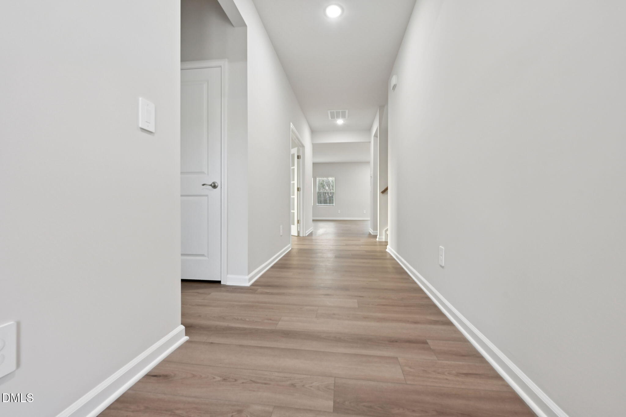 548 Bridger Drive Garner, NC 27529 - Photo 8 of 49 a view of a hallway with wooden floor