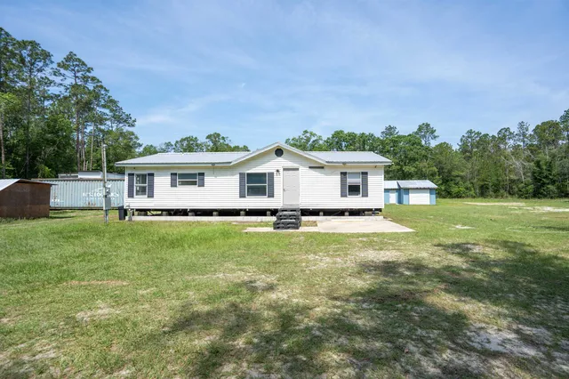 a front view of house with yard and green space