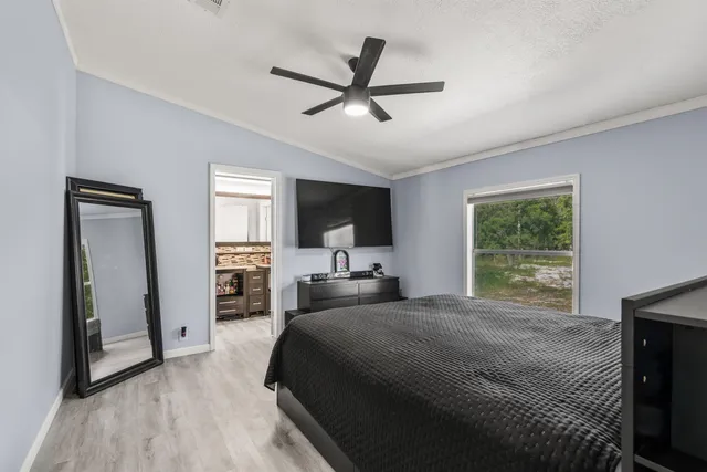 a bedroom with a bed and a large window