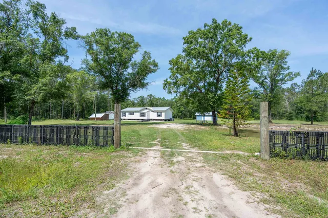a view of a yard with swimming pool