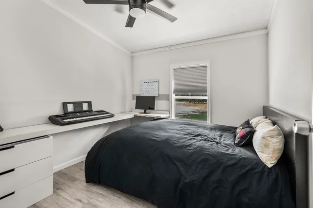 a bedroom with a bed and a window