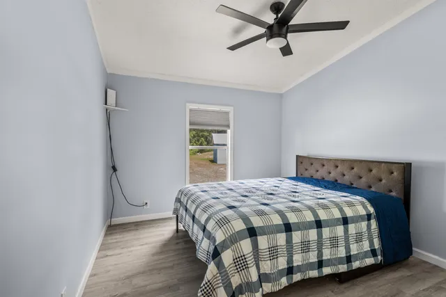 a bedroom with a bed and wooden floor