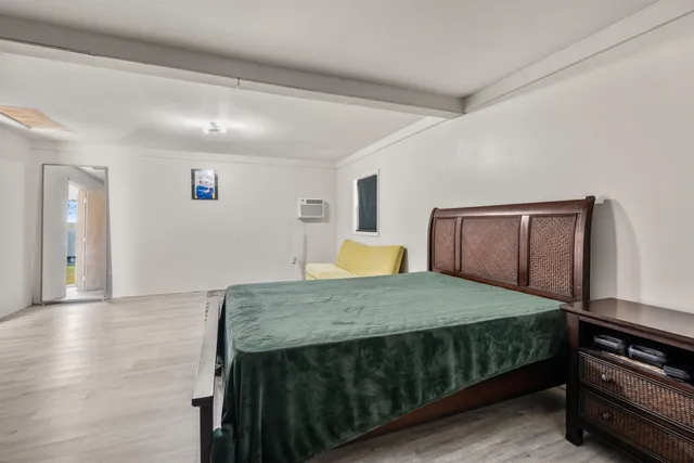 a bedroom with a bed and dresser