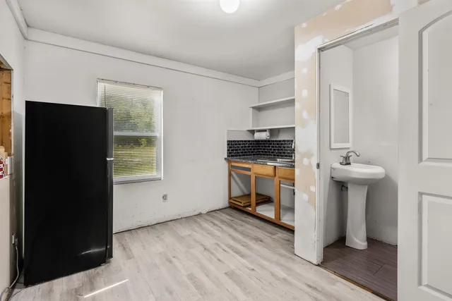 a kitchen with granite countertop white cabinets and white appliances