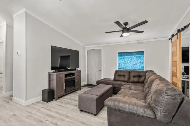 a living room with furniture and a flat screen tv