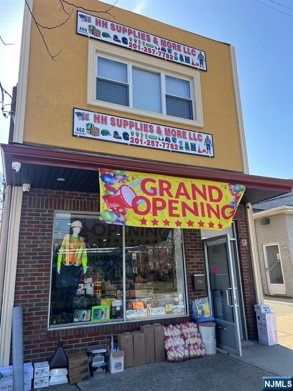 a front view of multi story commercial building with retail shops