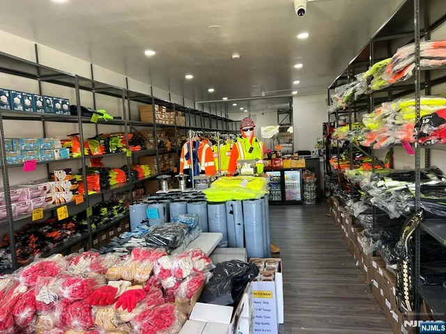a kitchen area with stainless steel appliances lots of fruit and lots of fruit