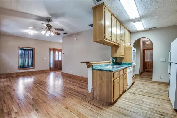 a kitchen with stainless steel appliances granite countertop a stove and cabinets
