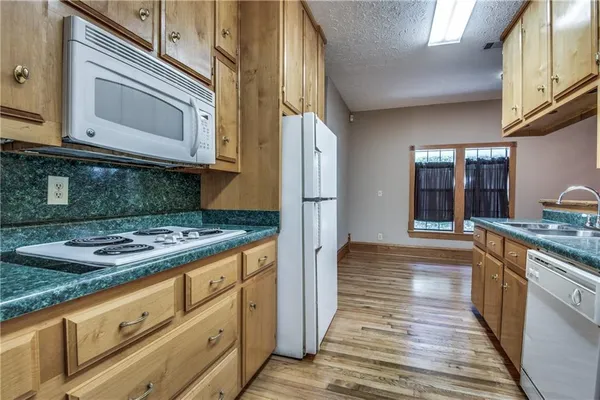 a kitchen with granite countertop a stove and cabinets