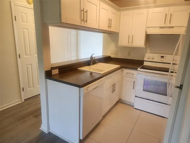 a white toilet sitting next to a bathroom sink and vanity