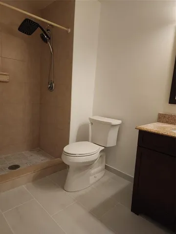a bathroom with a toilet and a mirror
