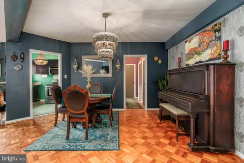a dining room with furniture a rug and wooden floor