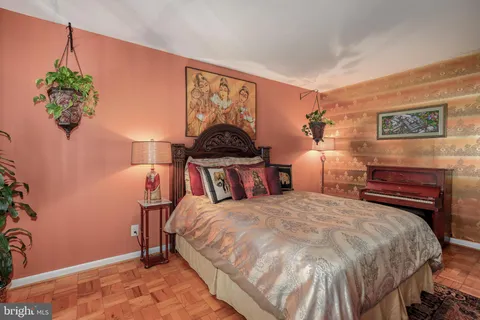 a bedroom with a bed and a potted plant