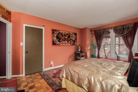 a bed sitting in a bedroom next to a window